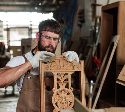Woodworker crafting ornate chair design